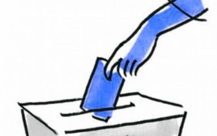 immagine di un'urna elettorale con introduzione della scheda di voto